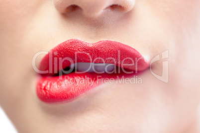 Close up on sensual model biting red lips