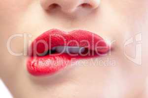 Close up on sensual model biting red lips
