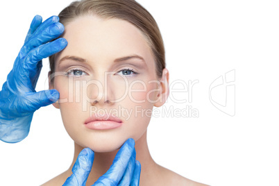 Surgeon examining serious pretty model