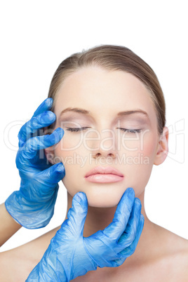 Surgeon examining peaceful gorgeous model