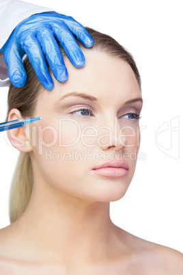 Calm young model having botox injection