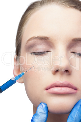 Content pretty model having botox injection on the cheek