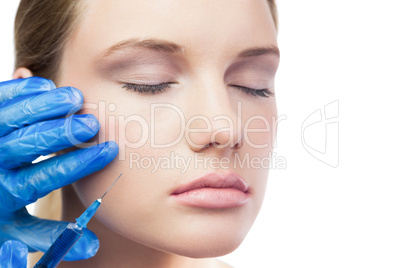 Relaxed cute model having botox injection on the cheek