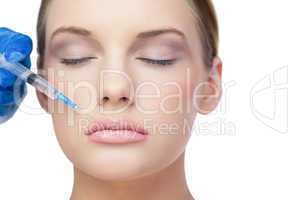 Relaxed beautiful model having botox injection above the lips