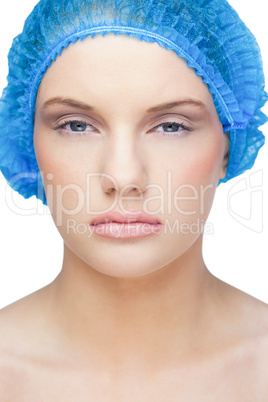 Calm pretty model wearing blue surgical cap