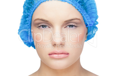 Content pretty model wearing blue surgical cap