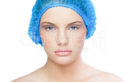 Serious pretty model wearing blue surgical cap