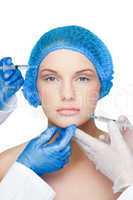 Surgeons making injection on content blonde wearing blue surgica