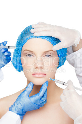 Surgeons making injection on pretty blonde