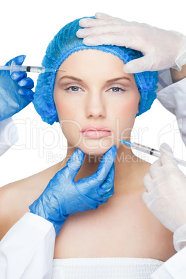 Surgeons making injection on gorgeous blonde