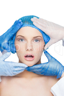 Surgeons examining surprised blonde