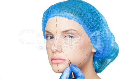 Surgeon drawing dotted lines on content patient