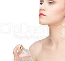 Beautiful nude model spraying perfume