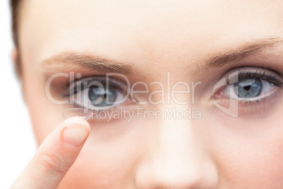 Pretty model holding contact lens