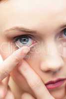 Cute model applying contact lens