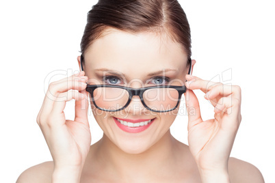 Smiling natural model looking over her classy glasses