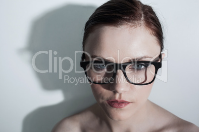 Serious clean model with classy glasses posing