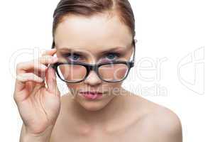 Serious clean model looking over her classy glasses