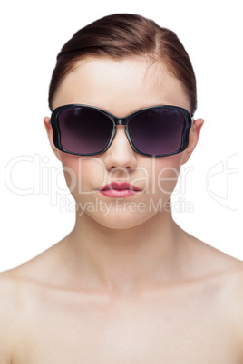 Serious young model wearing classy sunglasses