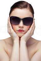 Serious young model wearing stylish sunglasses