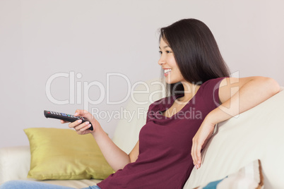 Happy asian girl watching tv