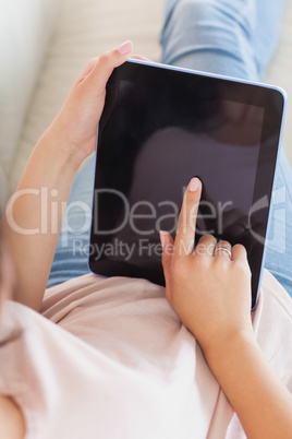 Girl using her tablet on the couch