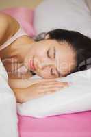 Pretty young asian woman sleeping in her bed