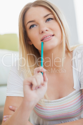 Thoughtful woman holding colour pencil