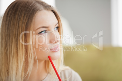 Thoughtful woman holding red pen