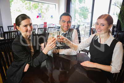 Business team celebrating a success with champagne in restaurant