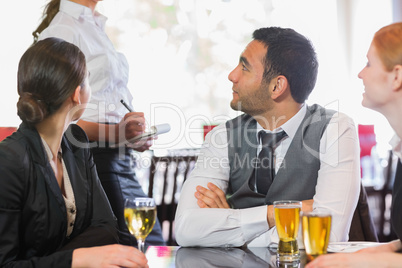 Business people talking to the waiter