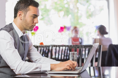 Concentrated businessman working on laptop