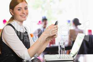Happy businesswoman sending a text
