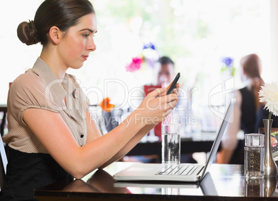 Businesswoman texting on phone