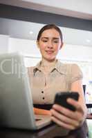 Happy businesswoman using phone