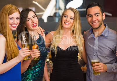 Portrait of smiling friends drinking beers
