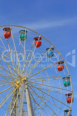 Atraktsion colorful ferris wheel against the blue sky