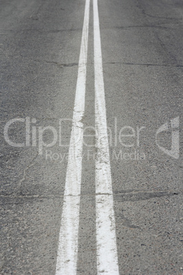 Asphalt highway with two white stripes