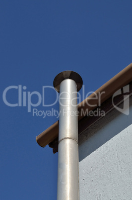 Metal chimney on side of the house