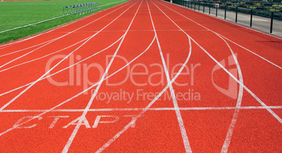 red treadmill at the stadium with white lines