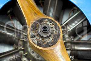 old aircraft engine with wood propeller, vintage plane close up