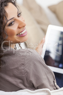 Hispanic Woman Laughing Using Tablet Computer