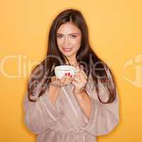 seductive woman wearing bathrobe and drinking hot coffee