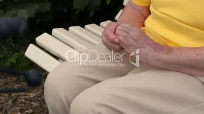 pensioner massaging her hands 11077
