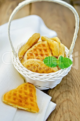 biscuit in the shape of hearts in a white basket with mint