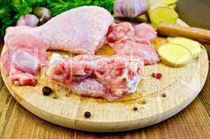 chicken leg cut on a wooden board