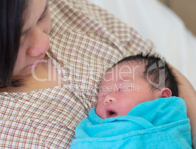 Newborn Asian baby and mother