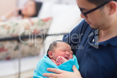 Newborn Asian baby girl and parents