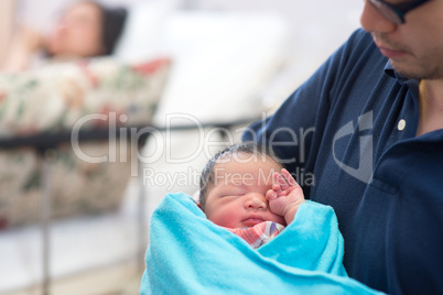 Newborn Asian baby and parents