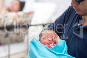 Newborn Asian baby and parents